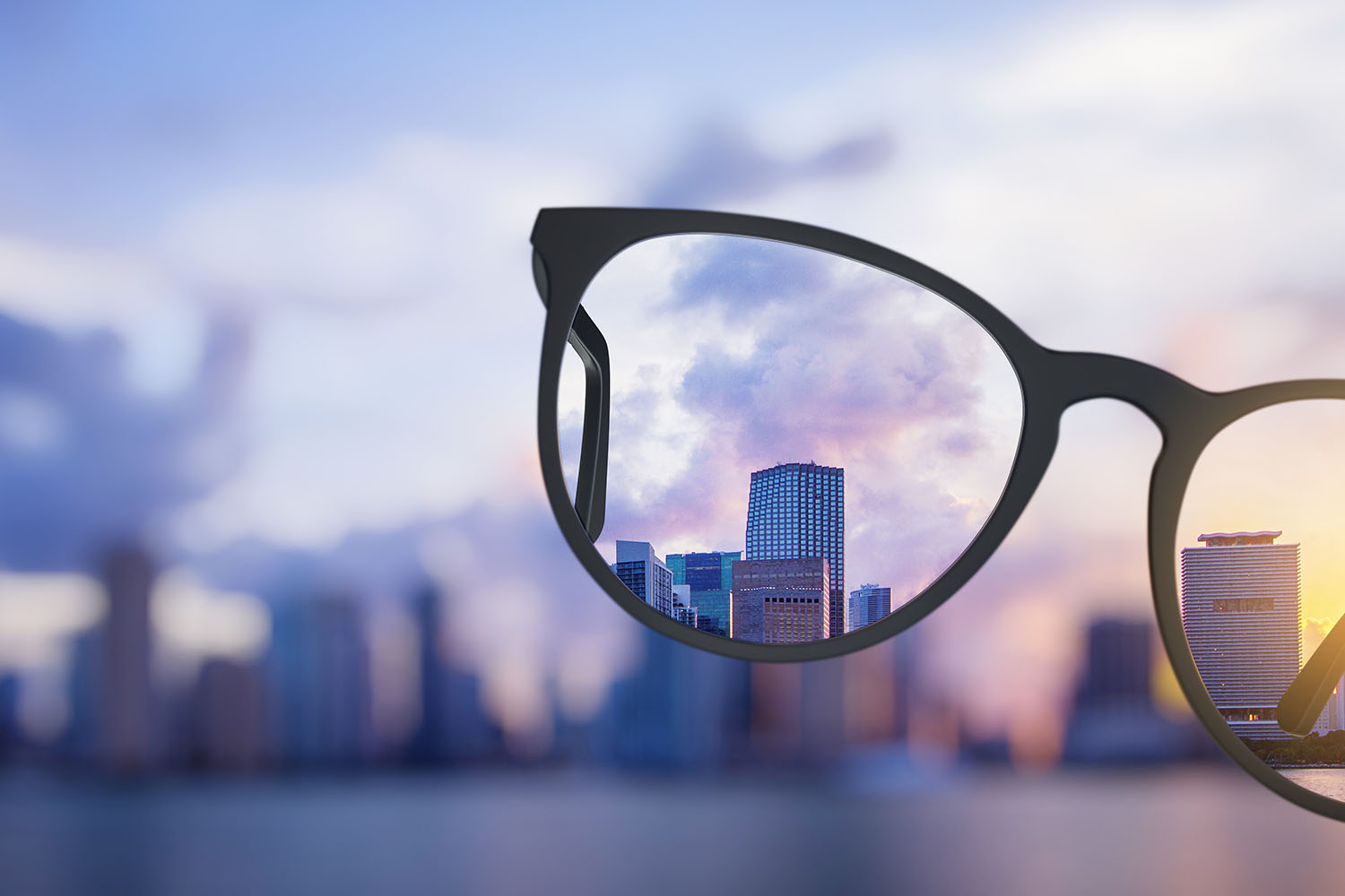 Modern bright city view through eyeglasses. Blurry background. Vision concept